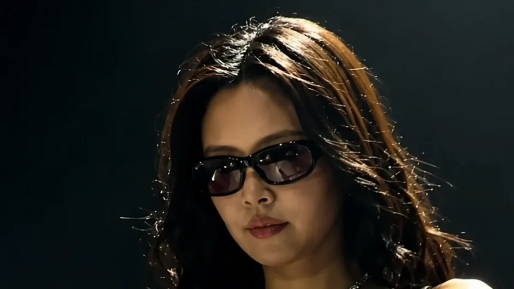 Jennie performing onstage in 2026 wearing dark sunglasses
