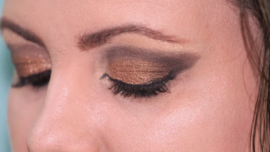 Close-up of winged eyeliner with bronze eye shadow