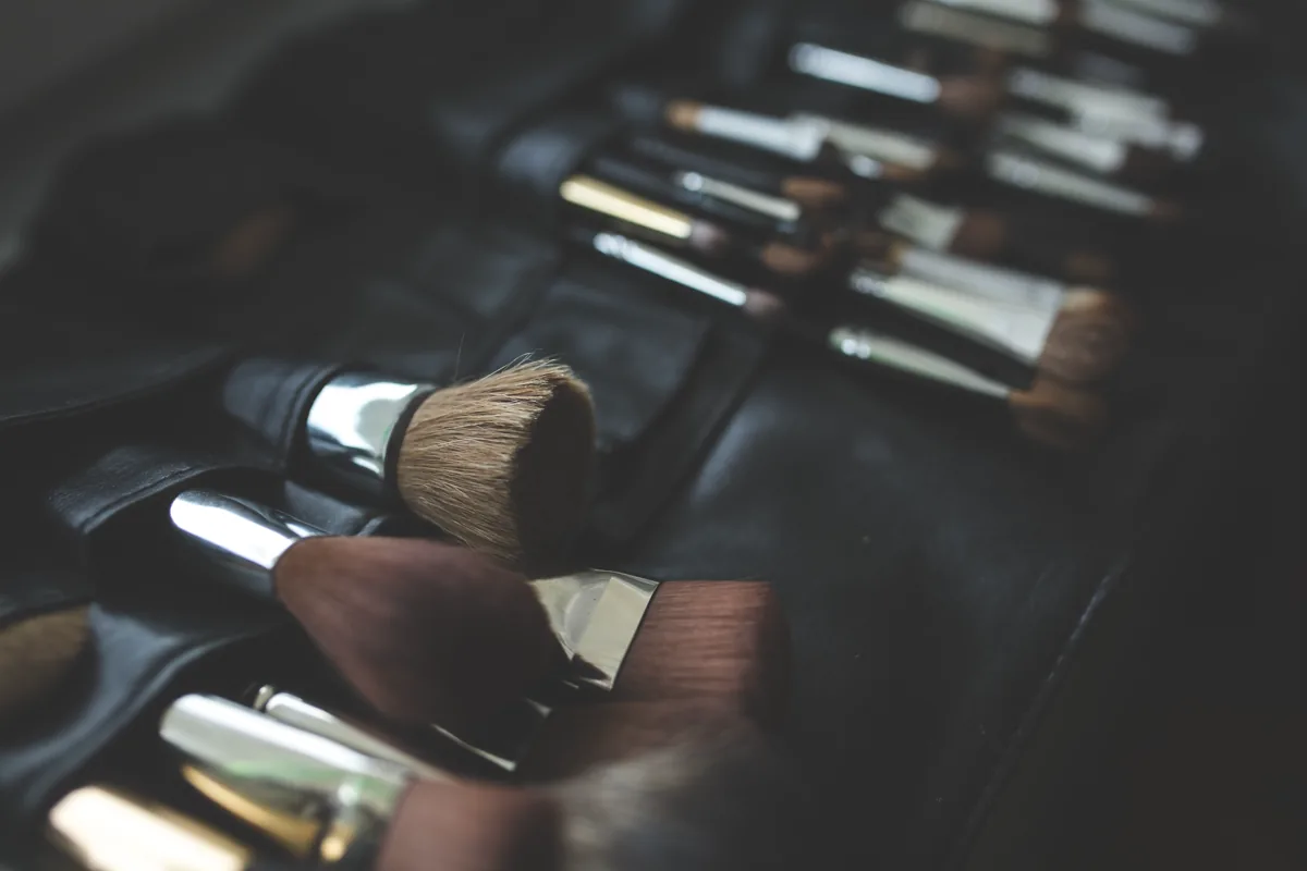 Face brushes arranged in an open makeup artist's brush case
