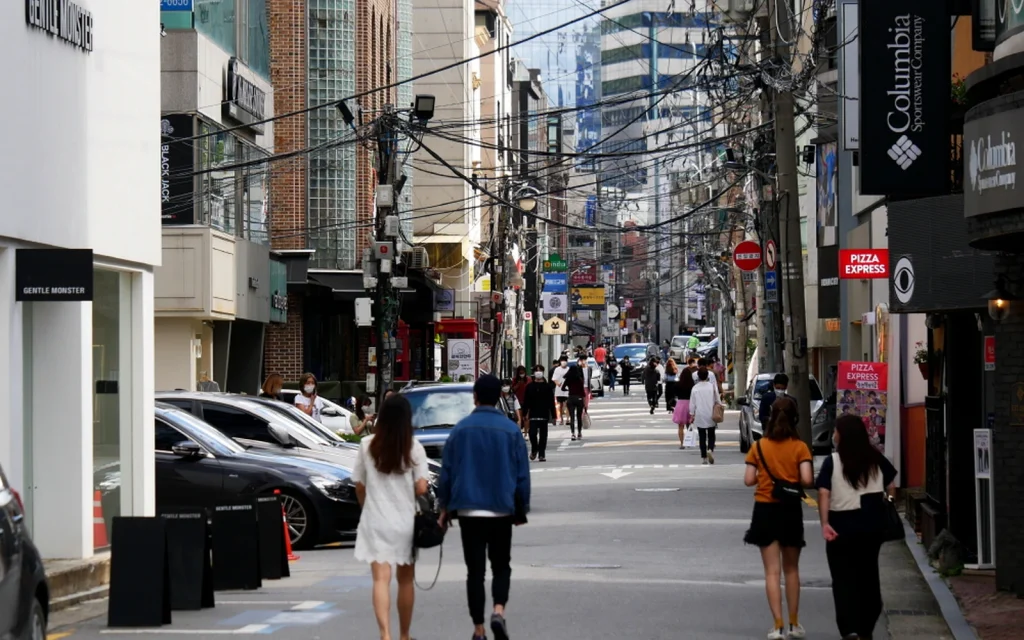 Shoppers walking past stores on Garosu-gil for a Korea tax refund receipt guide