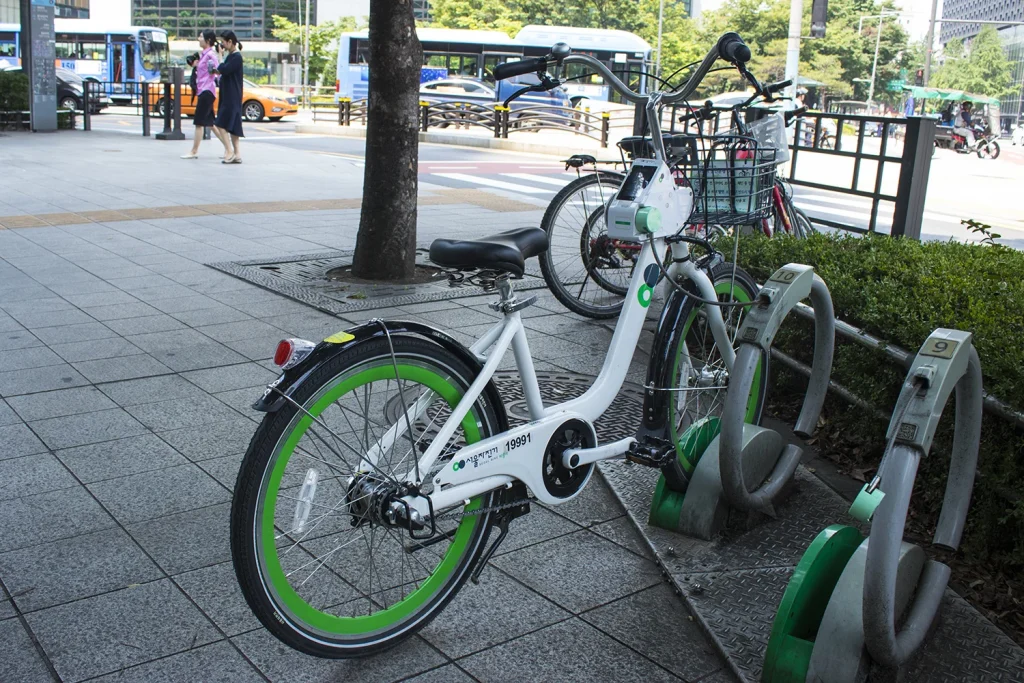 Green-and-white Ttareungi bicycle parked at a Seoul rental station in 2019